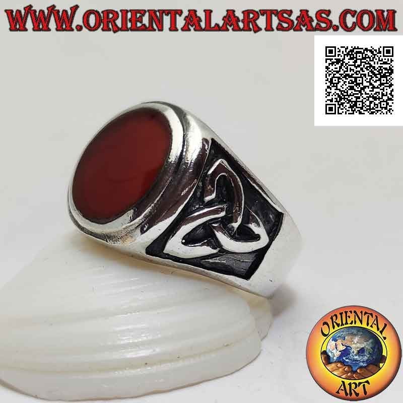 Silver ring with round carnelian flush with raised edge and bas-relief triquetra on the sides
