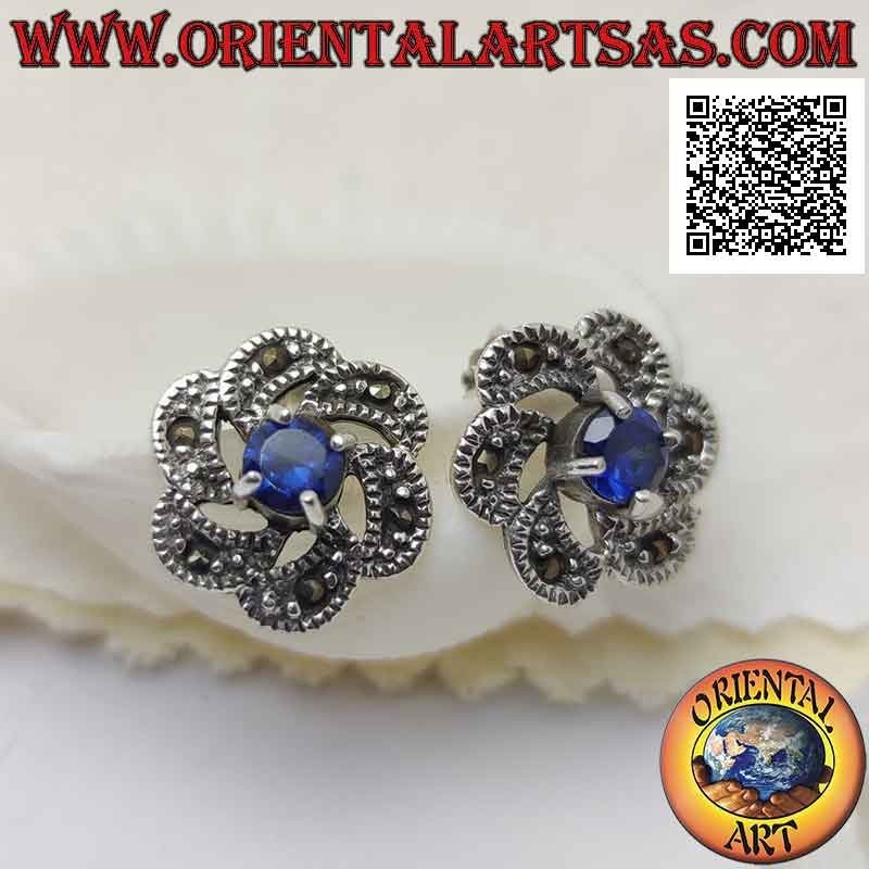 Silver lobe earrings with round synthetic sapphire in the center of a concentric and marcasite movement