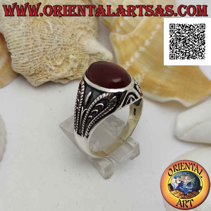 Silver ring with faceted oval carnelian and bas-relief oxidized grotesque decoration
