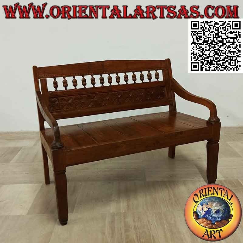 Antique bench with hand-carved flowers in teak wood