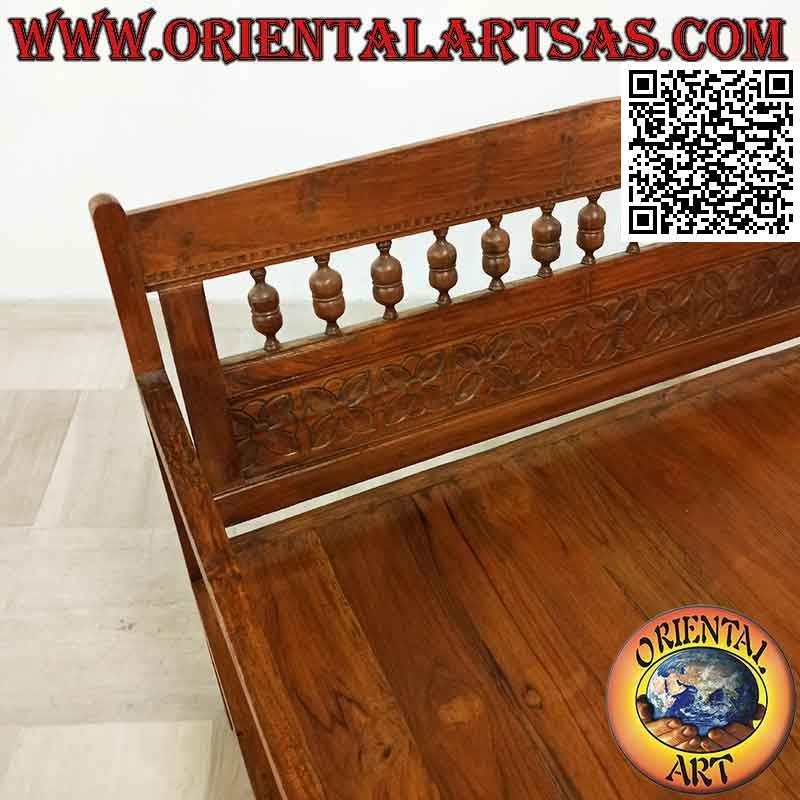 Antique bench with hand-carved flowers in teak wood