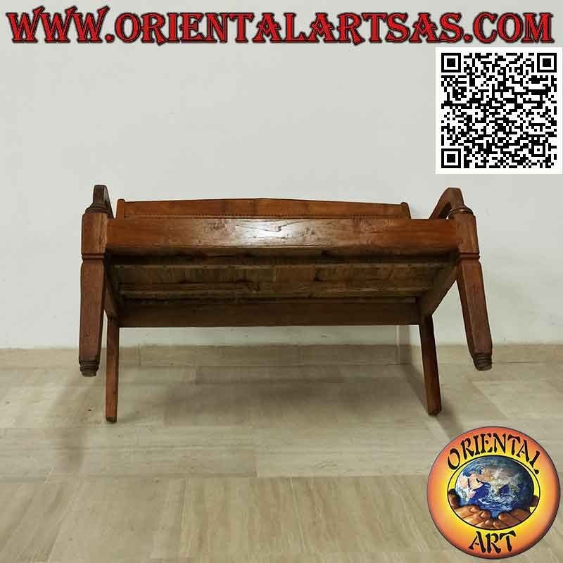 Antique bench with hand-carved flowers in teak wood