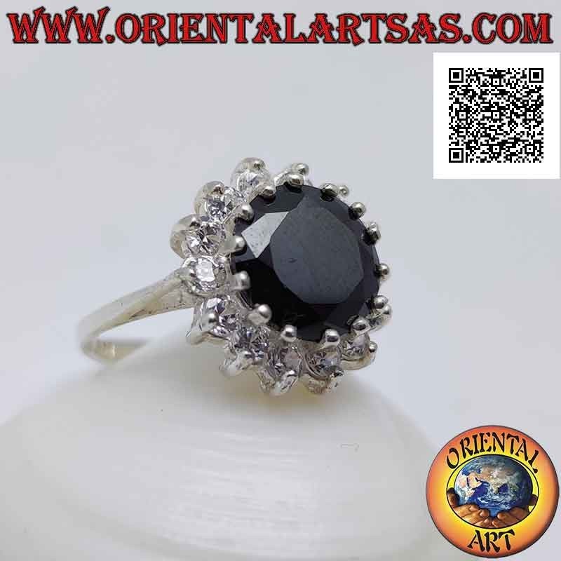 Silver ring with faceted round synthetic spinel set surrounded by white zircons