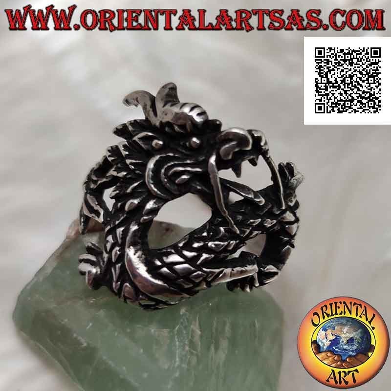 Silver ring in the shape of an oriental dragon with a mustache in motion and an enveloping tail