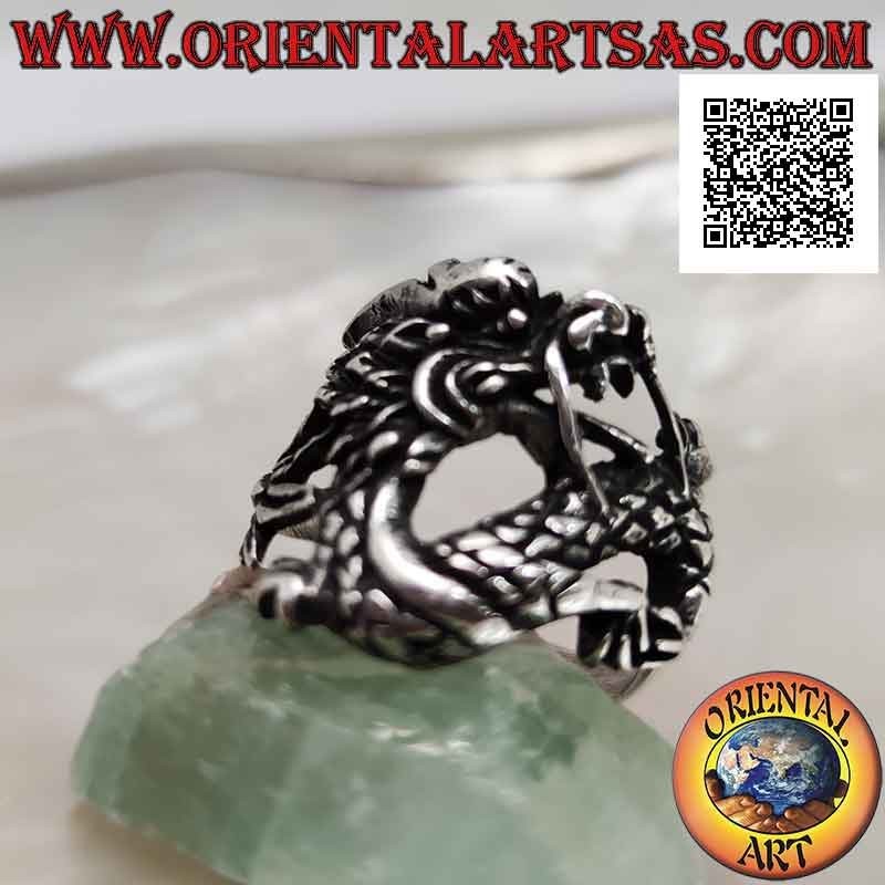 Silver ring in the shape of an oriental dragon with a mustache in motion and an enveloping tail
