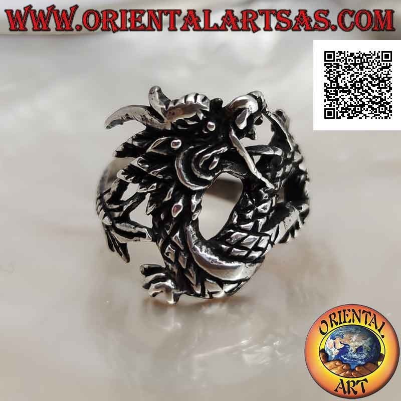 Silver ring in the shape of an oriental dragon with a mustache in motion and an enveloping tail