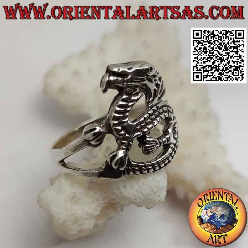 Silver ring in the shape of a stylized winged dragon in sinuous movement