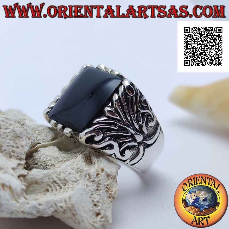 Silver ring with square onyx surrounded by baroque engravings on an imposing setting