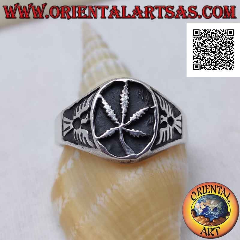 Silver ring with marijuana leaf in the oval in bas-relief and eagle on the sides