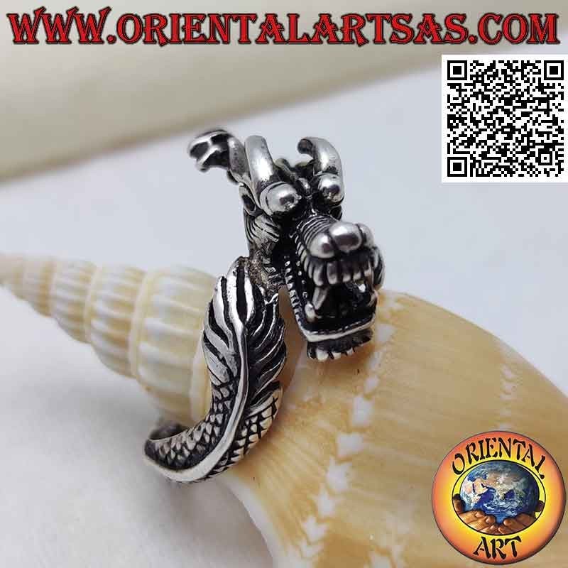 Silver ring in the shape of an enveloping Nepalese dragon with a snarling muzzle