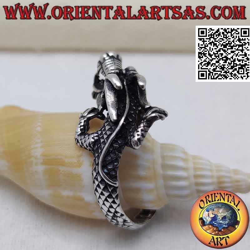 Silver ring in the shape of an enveloping Nepalese dragon with a snarling muzzle