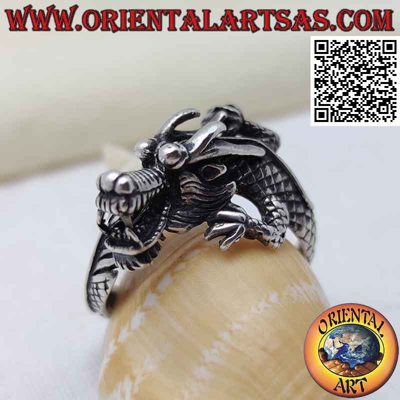 Silver ring in the shape of an enveloping Nepalese dragon with a snarling muzzle