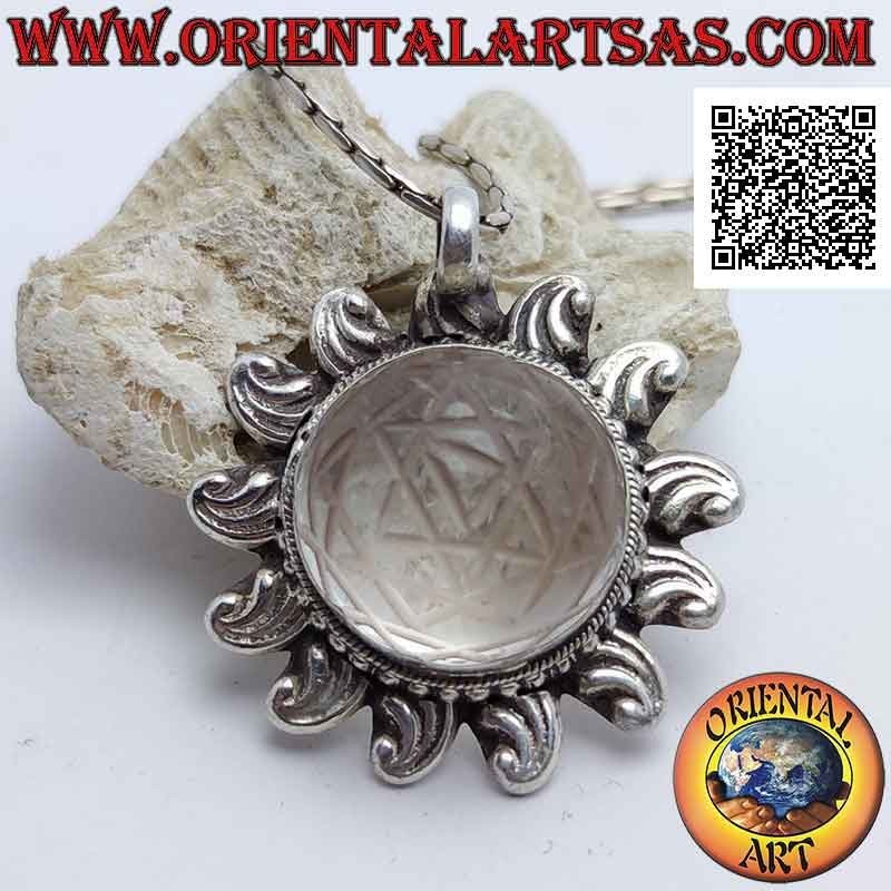 Silver pendant in the shape of a sun shaped with Sri Yantra engraved on central cabochon round rock crystal