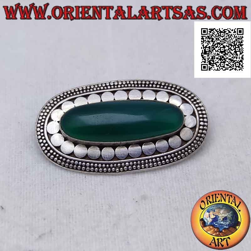 Silver brooch with elongated oval green agate surrounded by smooth studs and two rows of discs