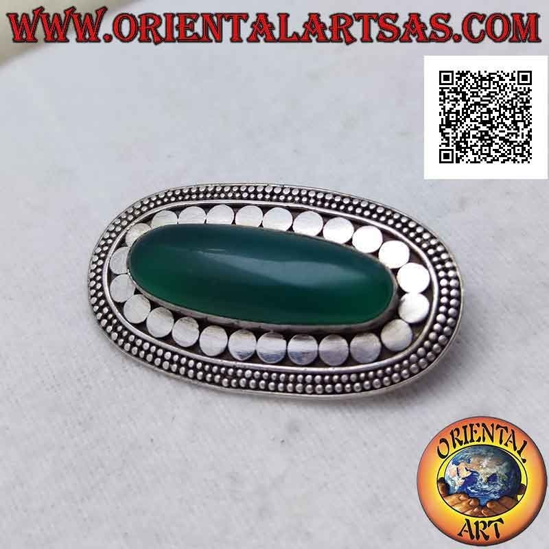 Silver brooch with elongated oval green agate surrounded by smooth studs and two rows of discs