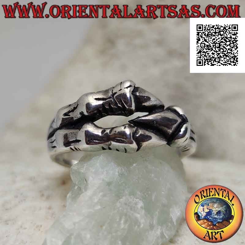 Silver ring in the shape of three dragon claws enveloping in a strong grip