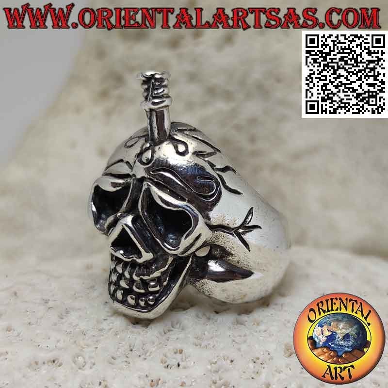 Silver ring in the shape of a suffering skull with a sword stuck in the skull