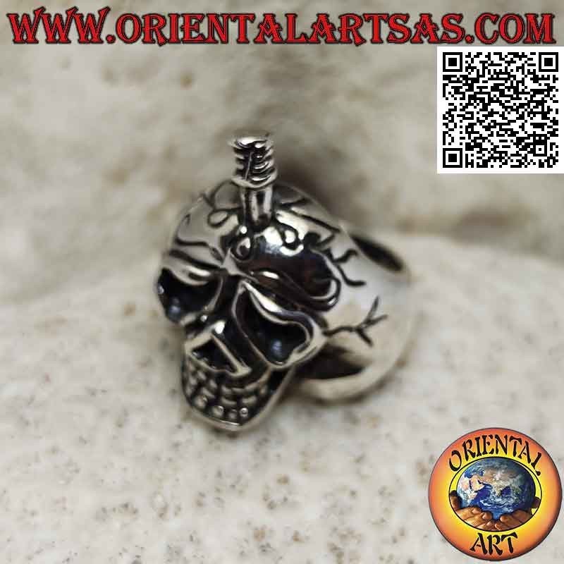 Silver ring in the shape of a suffering skull with a sword stuck in the skull