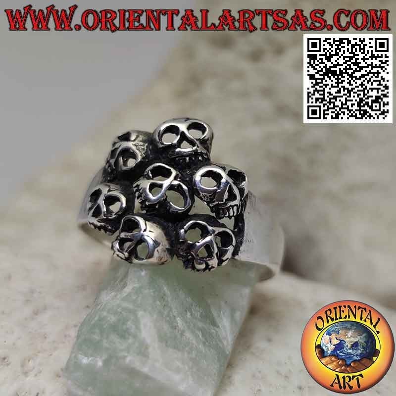 Silver ring with circle of seven perforated skulls
