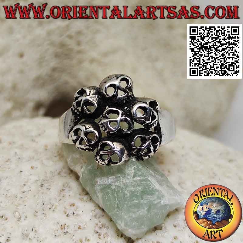 Silver ring with circle of seven perforated skulls