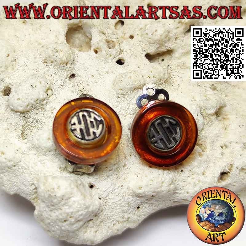 Clip-on silver earrings, amber disc with ethnic decoration inside
