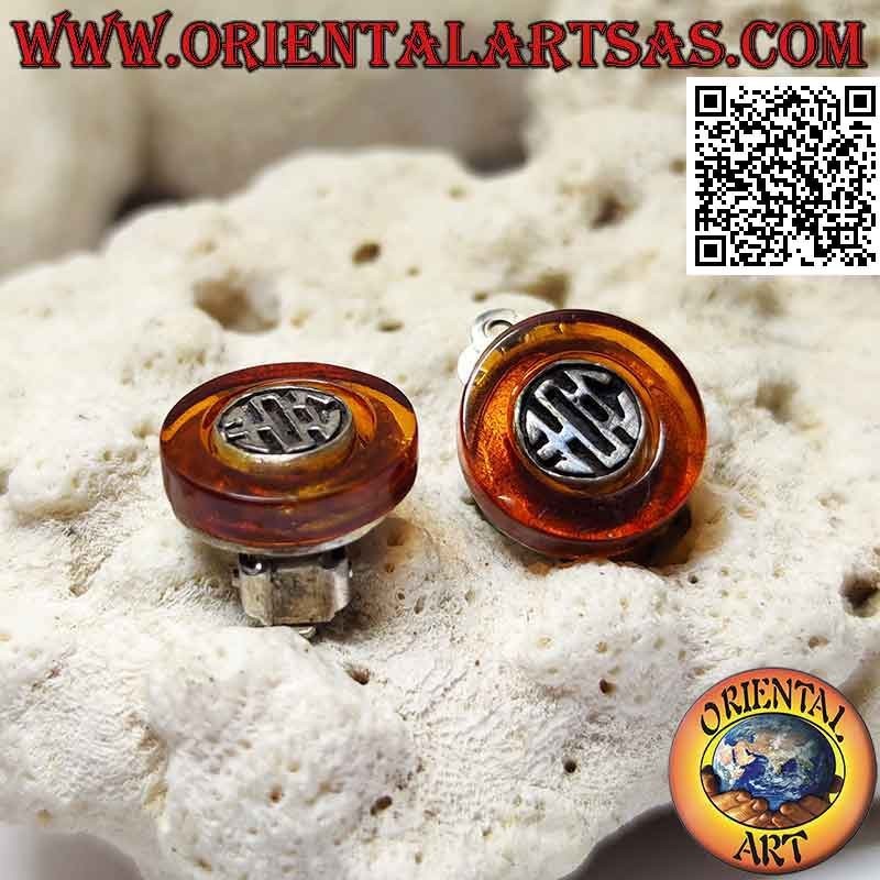 Clip-on silver earrings, amber disc with ethnic decoration inside