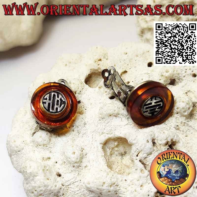 Clip-on silver earrings, amber disc with ethnic decoration inside