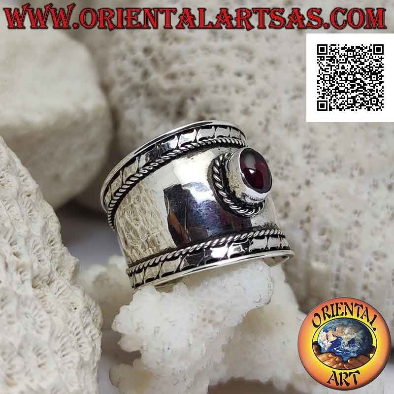 Wide band silver ring with oval garnet and intertwining and stripes on the sides, Bali