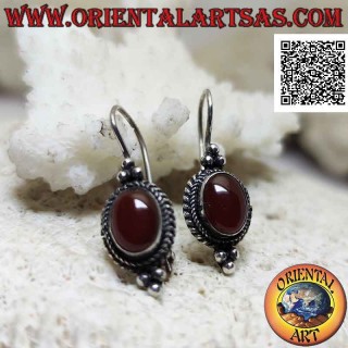 Silver earrings with cabochon oval carnelian surrounded by interweaving and trio of balls above and below