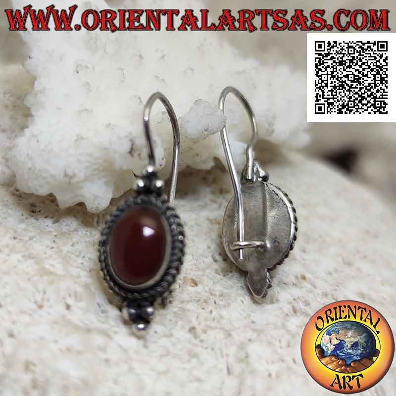 Silver earrings with cabochon oval carnelian surrounded by interweaving and trio of balls above and below