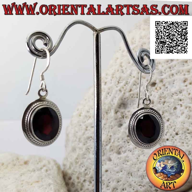 Silver earrings with faceted oval natural garnet and wide smooth edge with interweaving