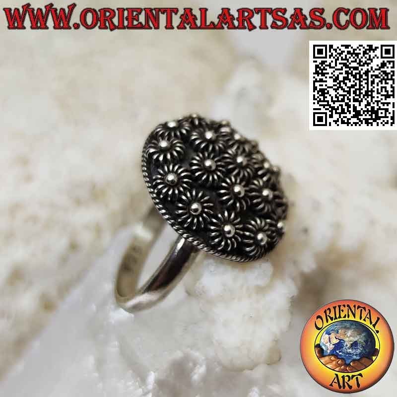Silver ring with round dome of bas-relief flowers