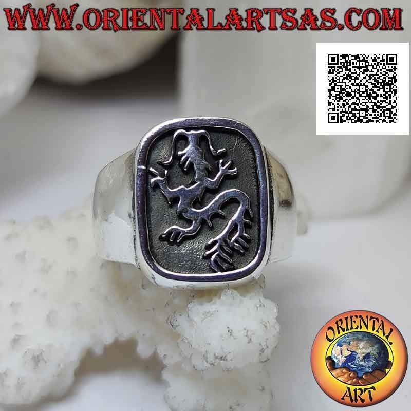 Smooth silver ring with lindworm (dragon) crawling in the curved rectangle in bas-relief