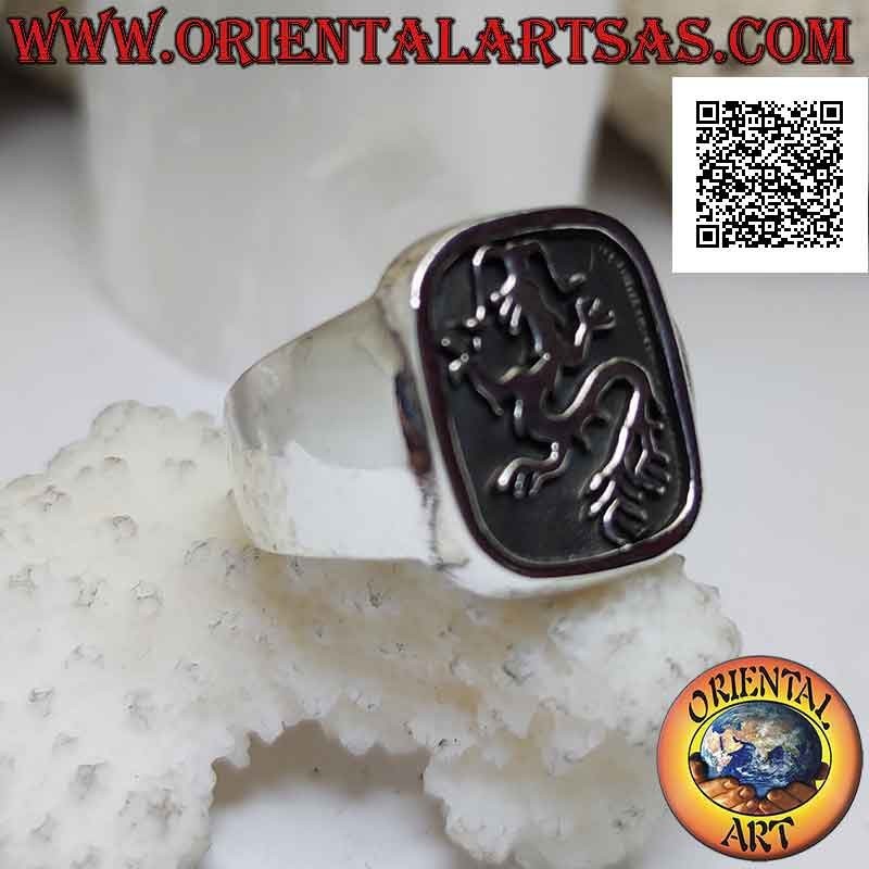 Smooth silver ring with lindworm (dragon) crawling in the curved rectangle in bas-relief