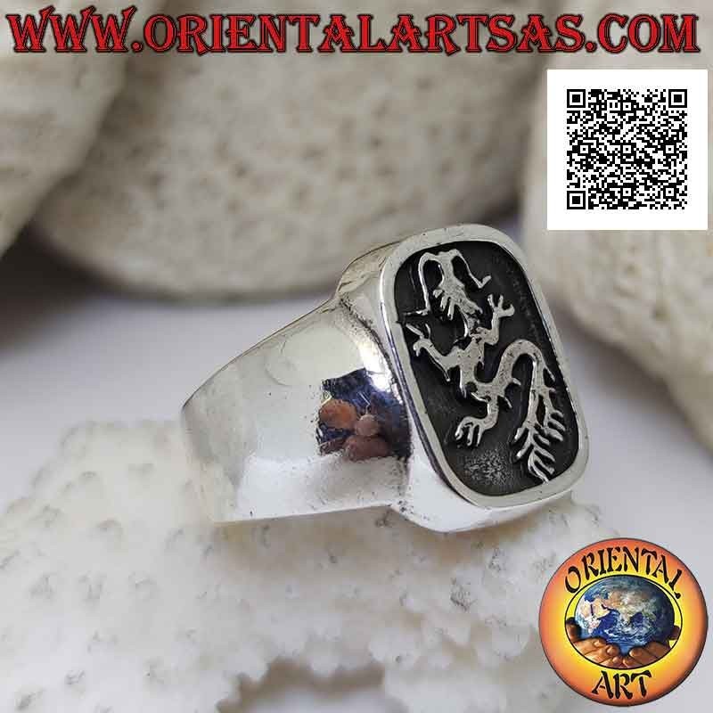 Smooth silver ring with lindworm (dragon) crawling in the curved rectangle in bas-relief