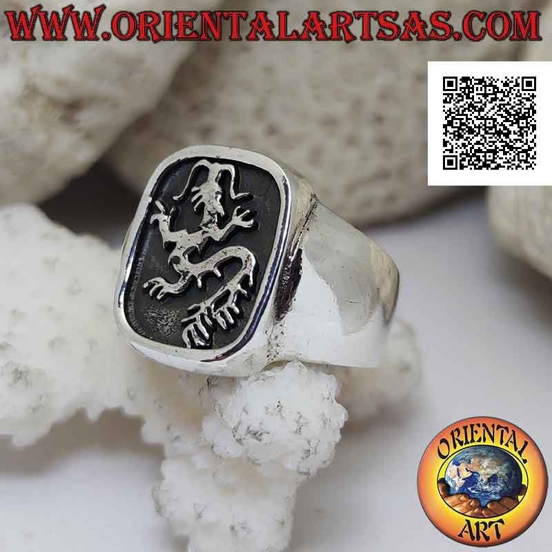 Smooth silver ring with lindworm (dragon) crawling in the curved rectangle in bas-relief