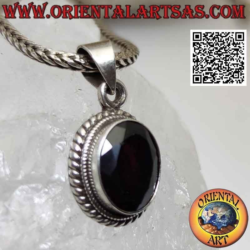 Silver pendant with natural oval faceted garnet surrounded by interweaving