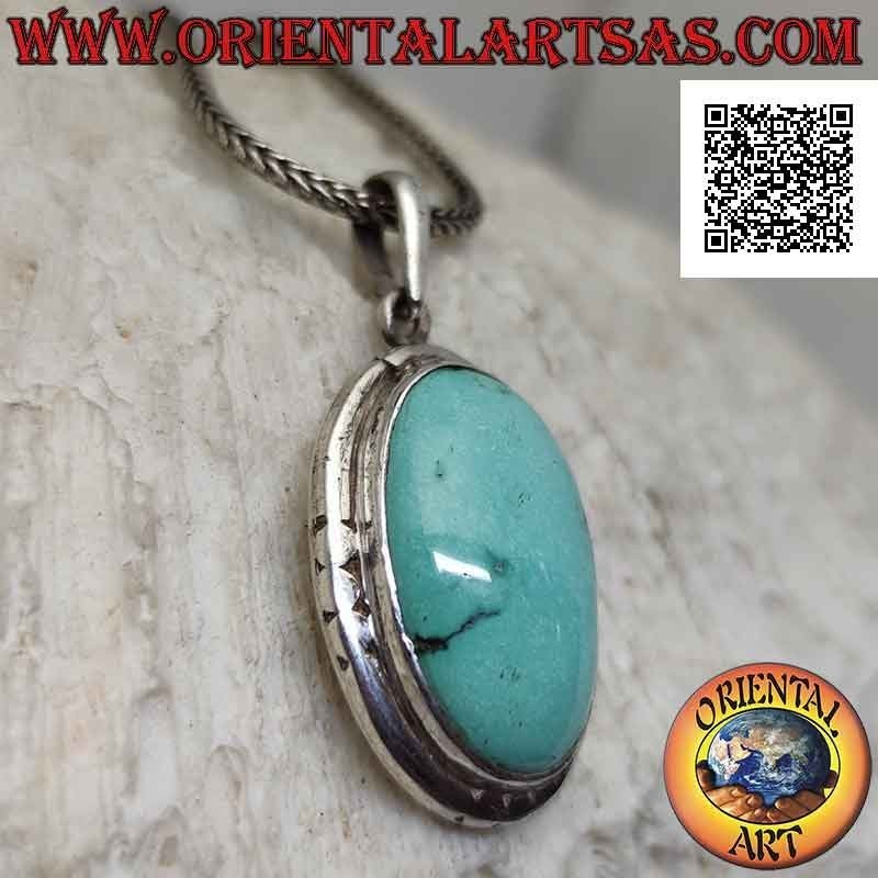 Silver pendant with oval antique turquoise and smooth protruding edge engraved on the cardinal points