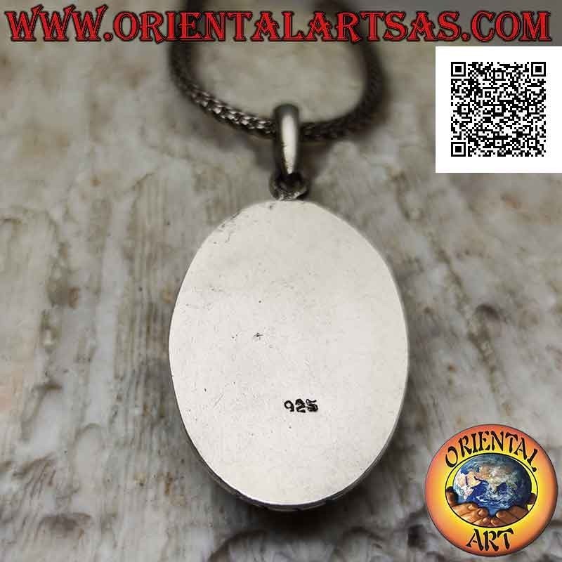 Silver pendant with oval antique turquoise and smooth protruding edge engraved on the cardinal points