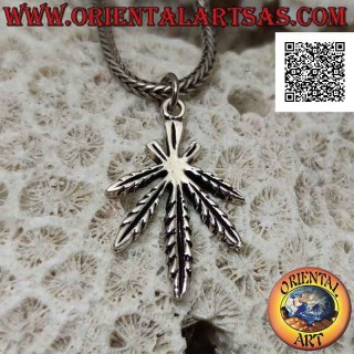 Silver pendant in the shape of a symmetrical marijuana leaf with deep engravings