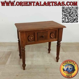 Ethnic coffee table with drawer among sunflowers in relief in teak wood