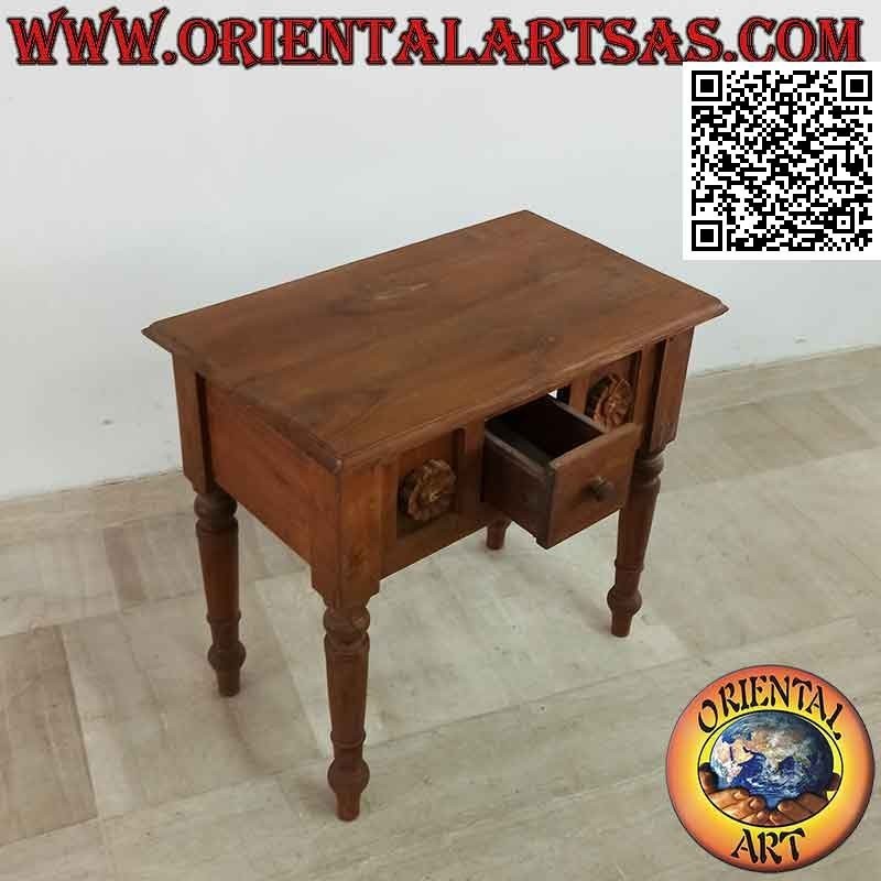 Ethnic coffee table with drawer among sunflowers in relief in teak wood