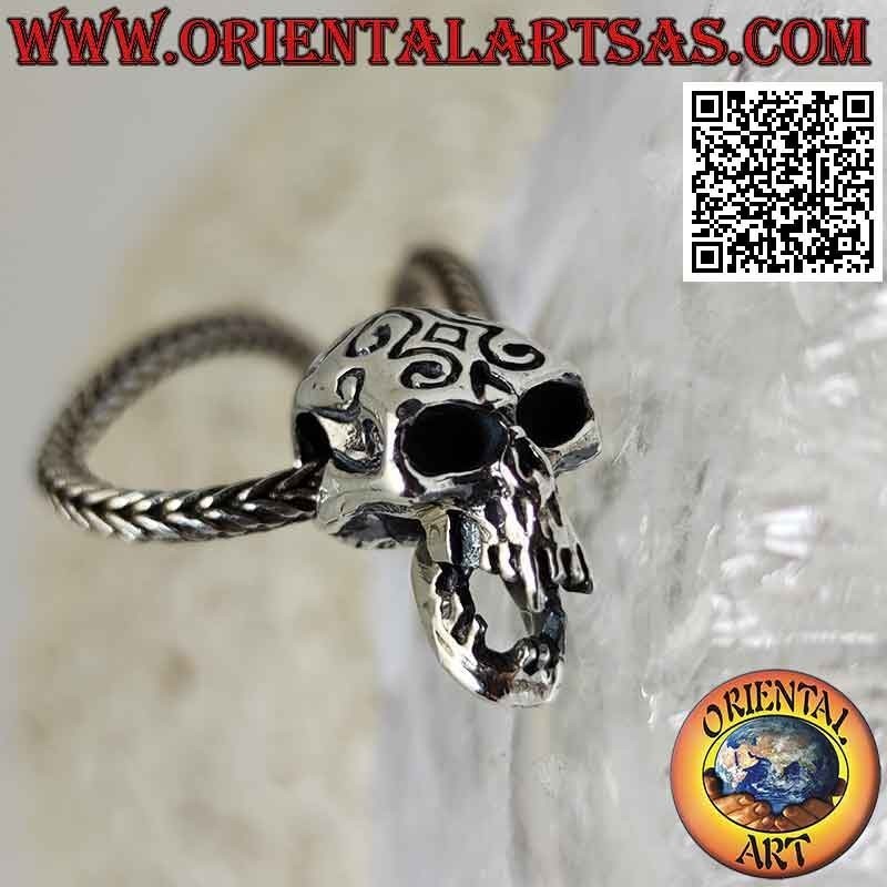 Silver pendant in the shape of a skull with engraved Maori and pierced temples