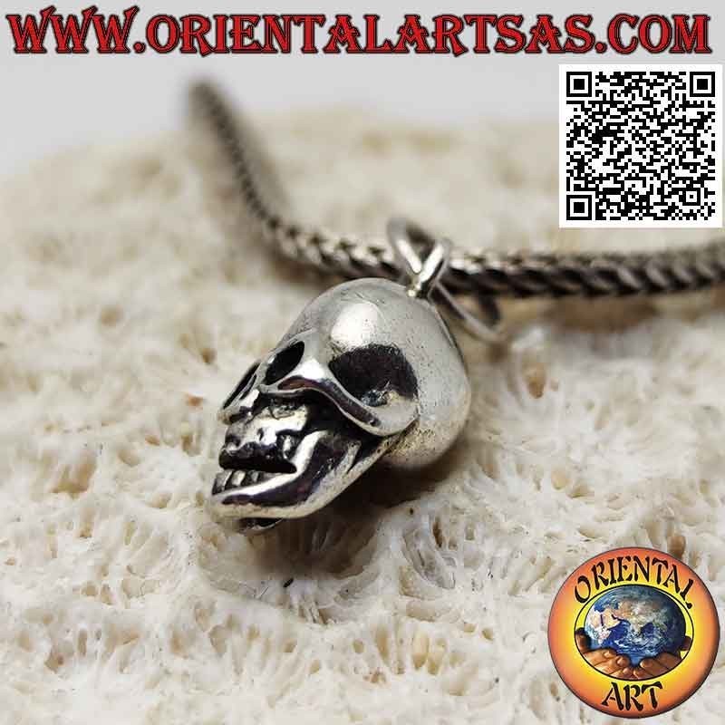 Silver pendant in the shape of a three-dimensional skull with wide open eyes (small)