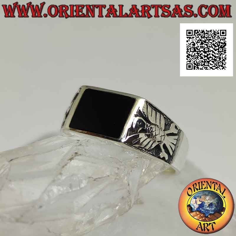 Silver ring with horizontal rectangular onyx flush with the edge and eagle in bas-relief on the sides