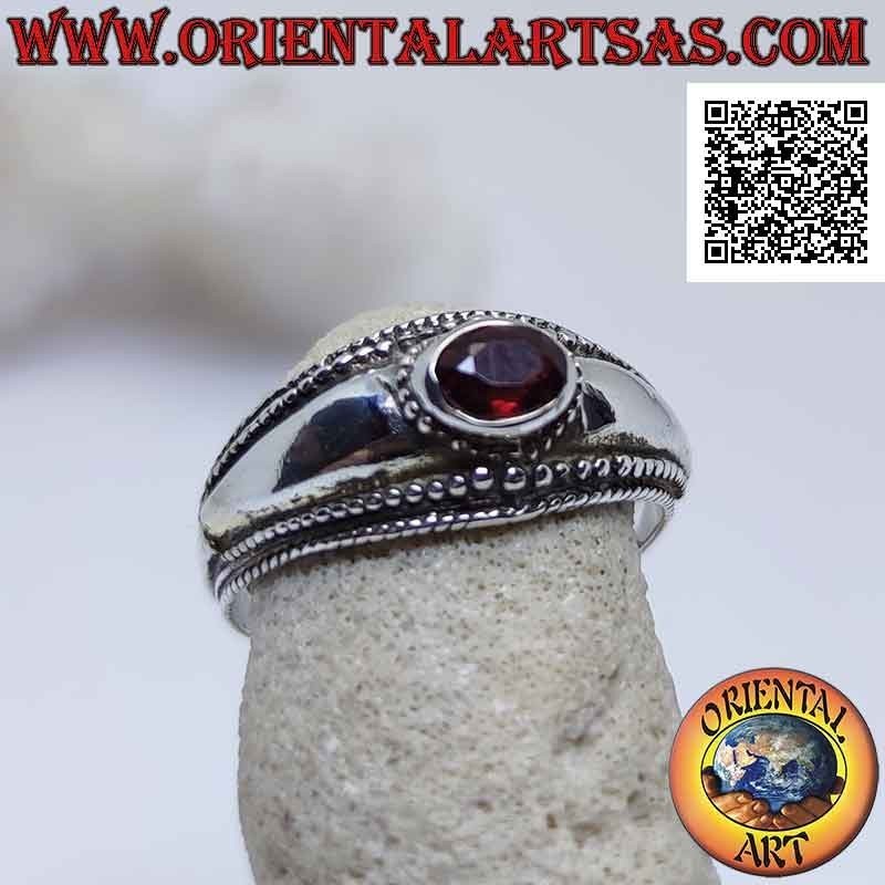 Anillo de plata con granate ovalado horizontal y decoración de bolas.