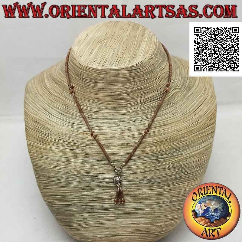 Choker necklace of tubes and fragments of raw brown jade and 925 ‰ silver strung with a tuft