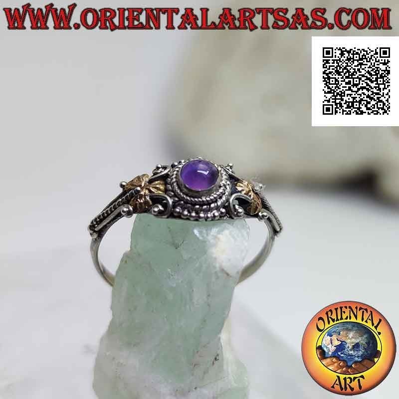 Ethnic style silver ring with round cabochon amethyst and 14 karat gold plates on the sides