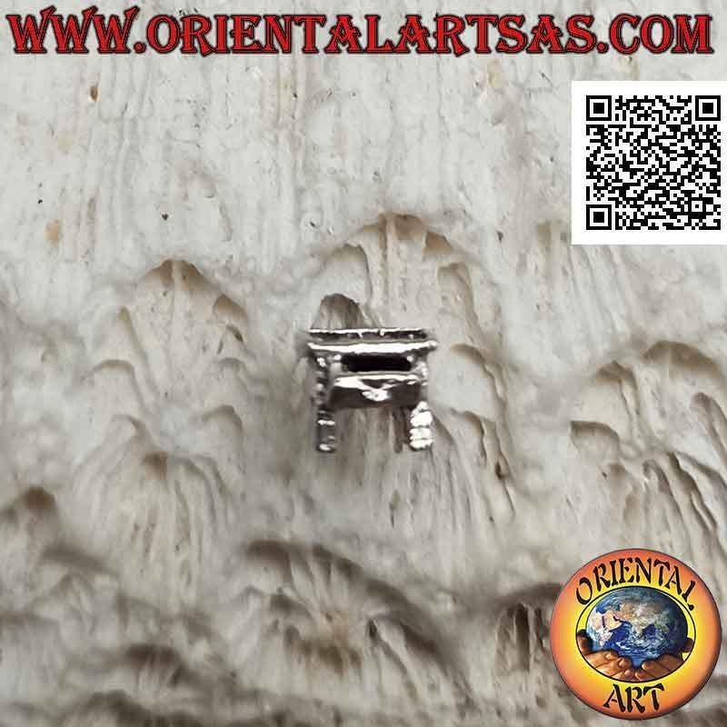 Mini silver earring, the school desk