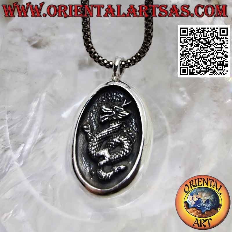 Silver pendant, oval medal with Nepalese dragon in bas-relief